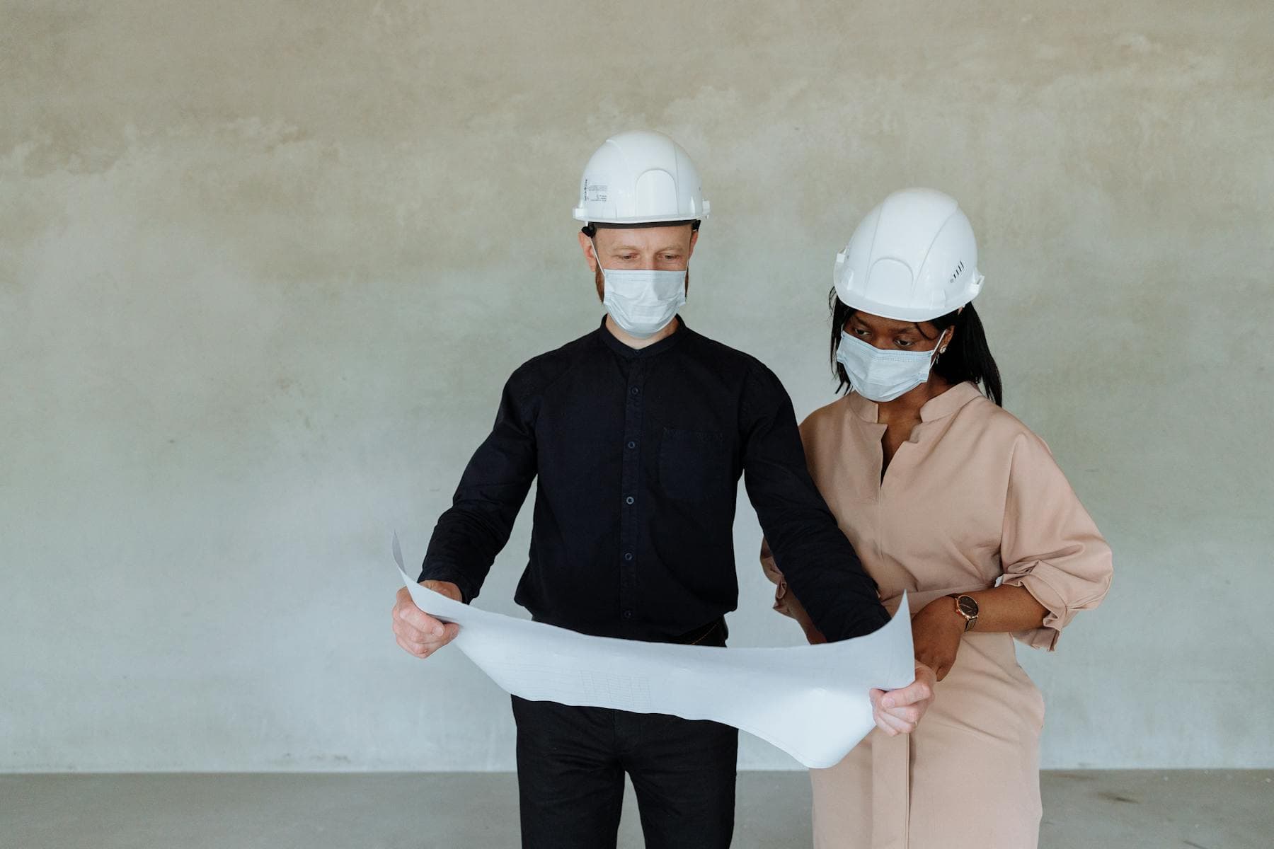 Architects reviewing building plans indoors